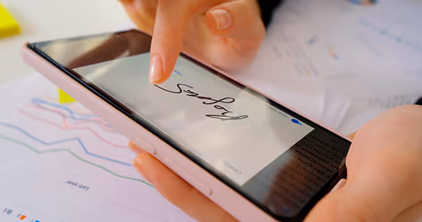 Image of a woman electronically signing a healthcare form
